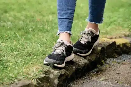Personne changeant de chaussures en passant de sandales à des chaussures fermées, illustration de la transition de rentr